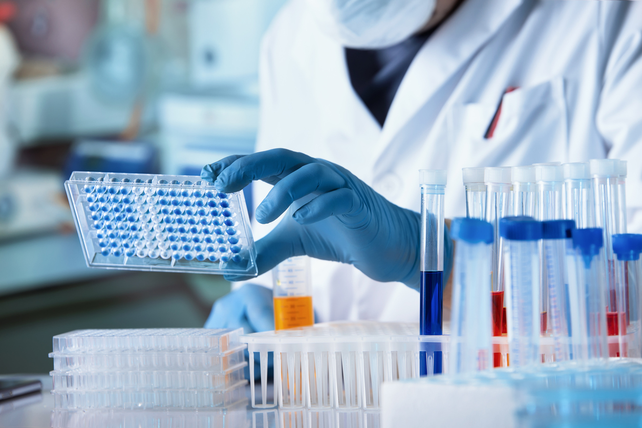 biodegradable testing labs — Doctor working with microplate for elisa analysis